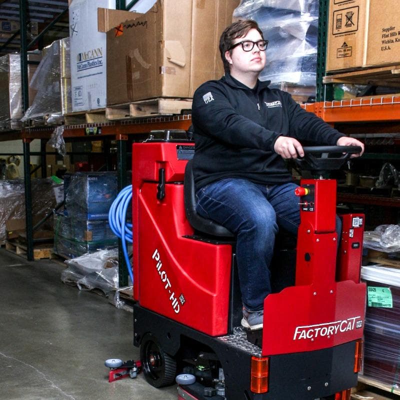 FactoryCat Ride On Floor Scrubbers Pilot warehouse concrete - https://assets.factorycat.com/demoImages/2025/april/Pilot-Ride On Floor Scrubbers-warehouse-concrete-Waco-USA-846.jpg - 800 - 800 - 846 A FactoryCat Pilot Ride On Floor Scrubber cleans the concrete aisles in a Waco, Texas fabrication shop warehouse